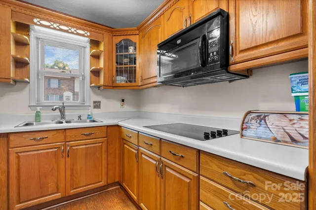 a kitchen with stainless steel appliances granite countertop a sink and cabinets