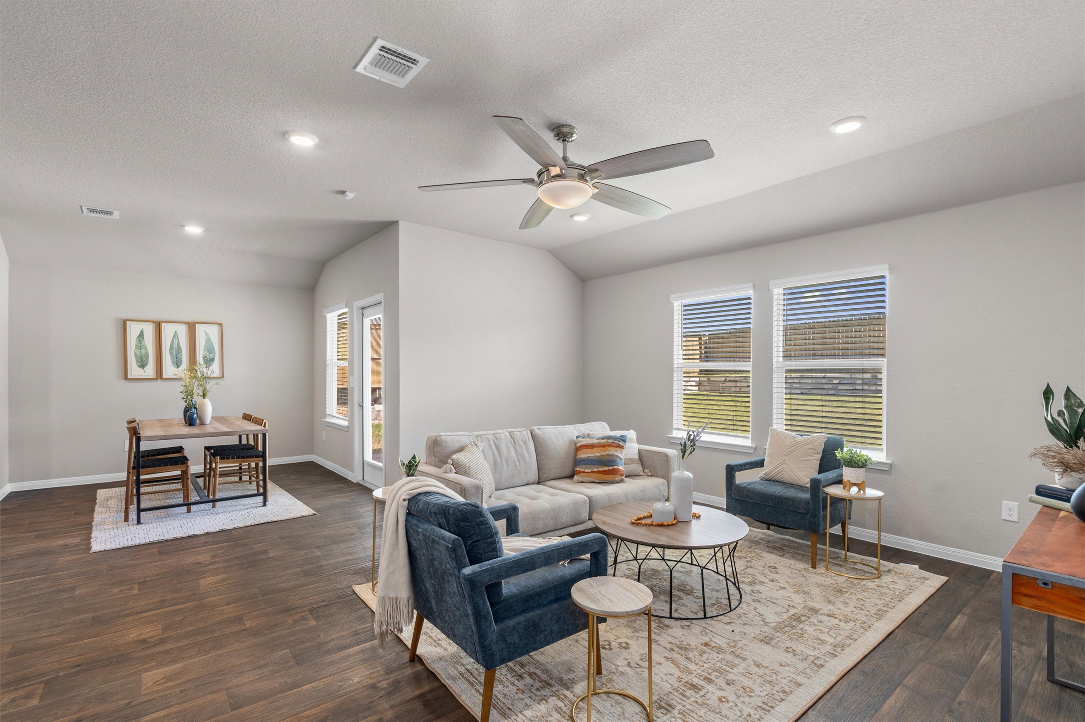 19525 Abigail Fillmore Road Manor, TX 78653 - Photo 2 of 38 A welcoming gathering space with a dining area features rich wood flooring and abundant natural illumination.