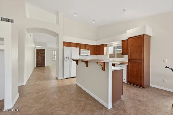 a view of a kitchen with furniture and wooden floor