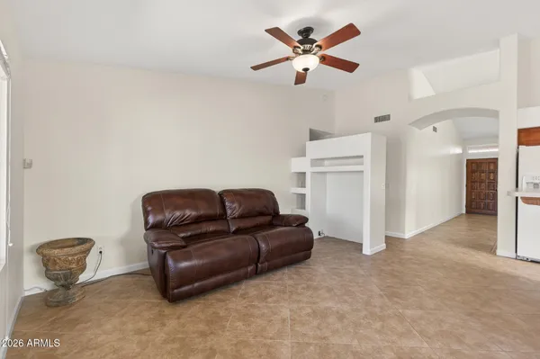 a view of a big room with chandelier fan and closet area