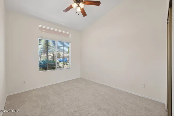 a view of a porch with chairs and floor to ceiling window