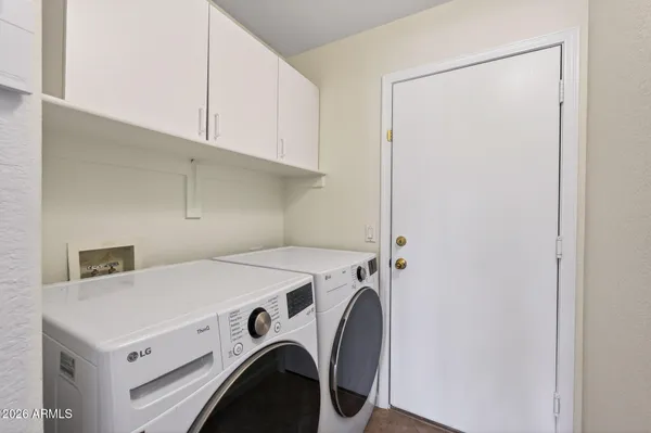 a front view of a house with a garden and patio