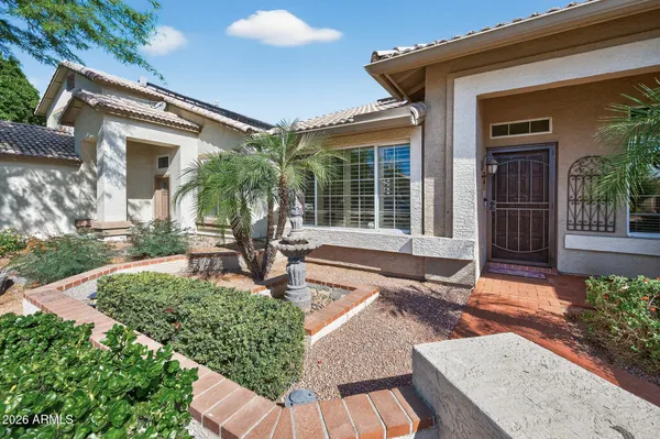 a view of an empty room with a window and a kitchen