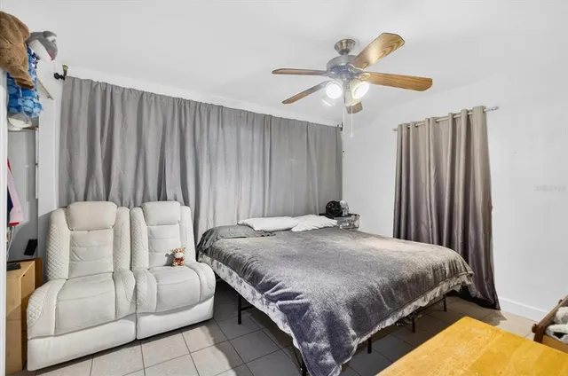 a bedroom with a bed and ceiling fan