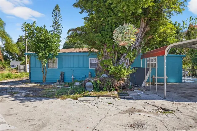 a view of a chair and table in the backyard