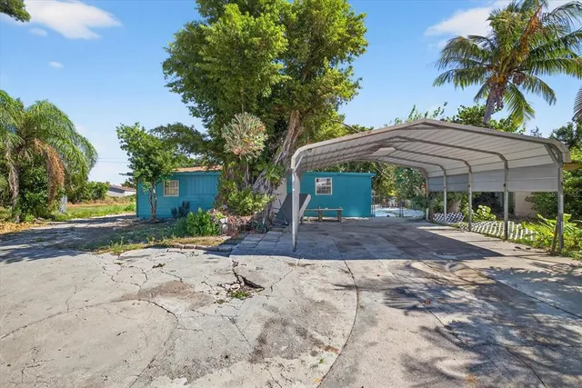 a view of a patio with a table and chairs under an umbrella