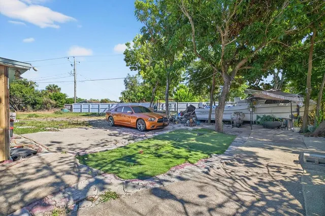 a backyard of a house with a table and chairs