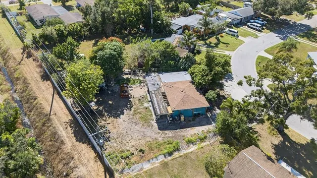 an aerial view of residential house with outdoor space and swimming pool