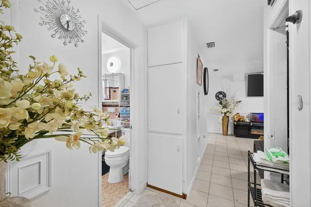 a bathroom with a sink a toilet and shower curtain