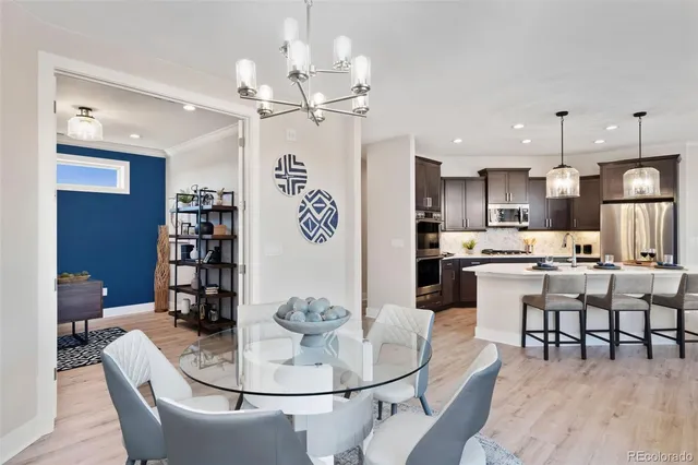 a living room with dining room and kitchen view