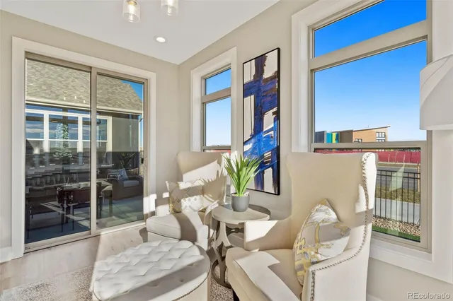 a living room with furniture and a floor to ceiling window