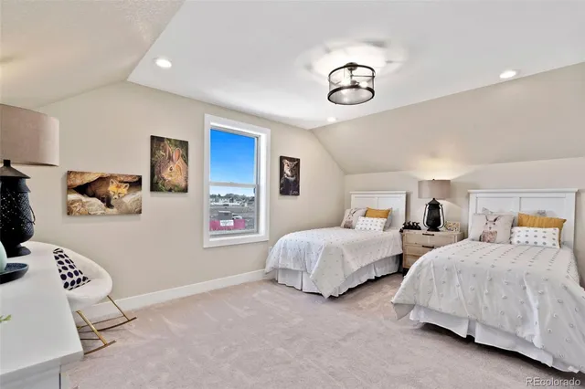 a bedroom with two beds and a chandelier