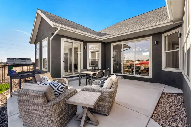 a outdoor space with patio the couches and a dining table with large mirror