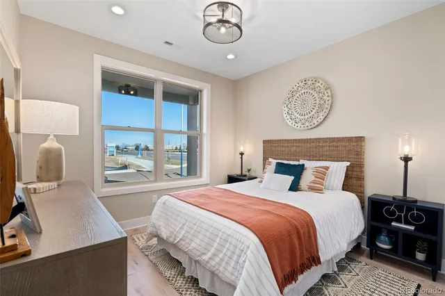 a bedroom with a bed and a table with lamp