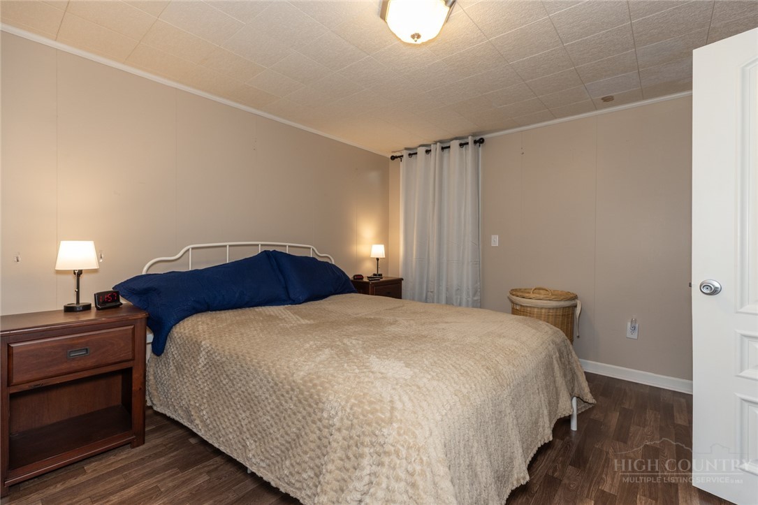 1335 Shingle Gap Road Purlear, NC 28665 - Photo 43 of 49 a bedroom with a bed and a lamp