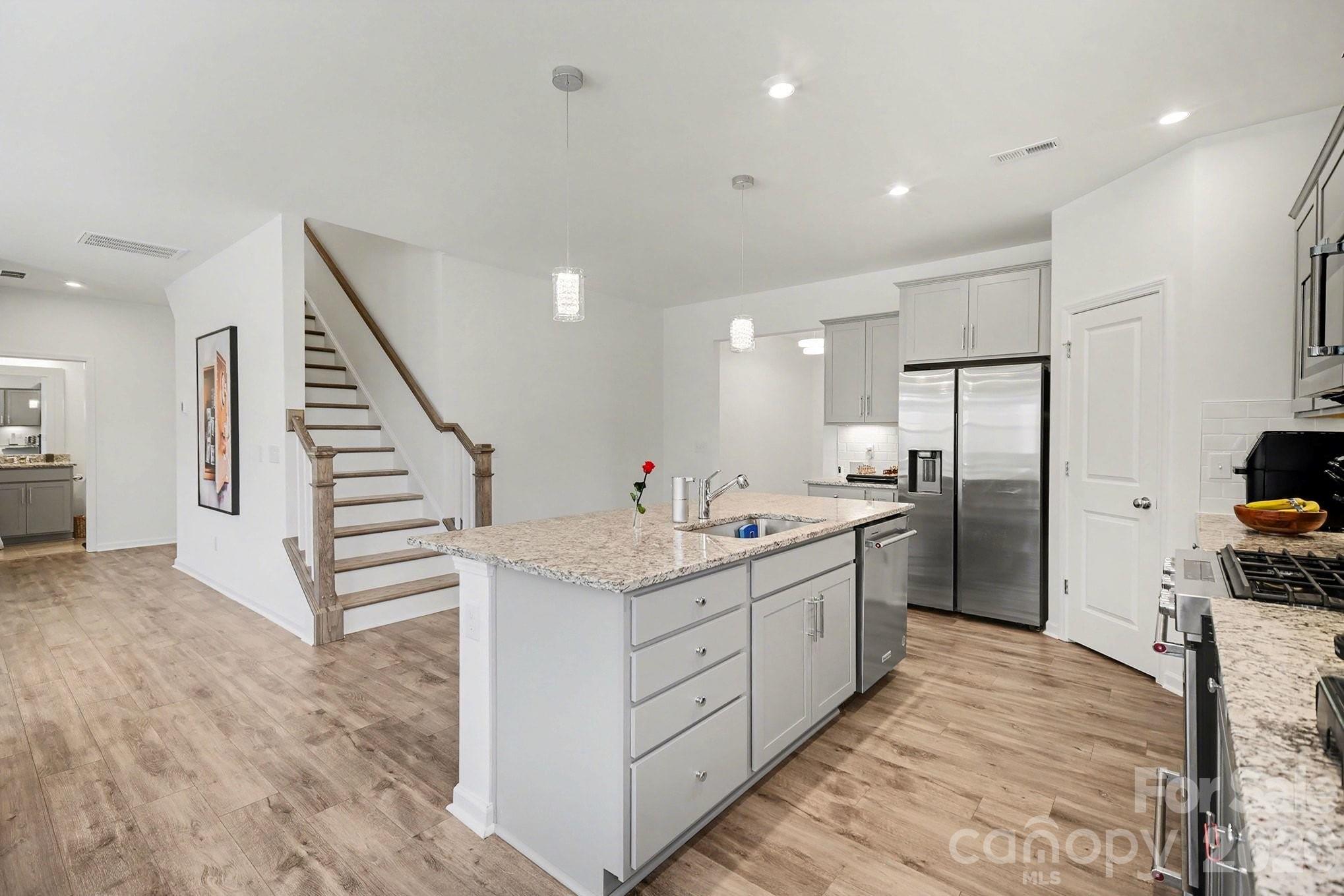11122 Glasden Road Charlotte, NC 28278 - Photo 11 of 32 a large kitchen with stainless steel appliances kitchen island granite countertop a large counter top and a sink