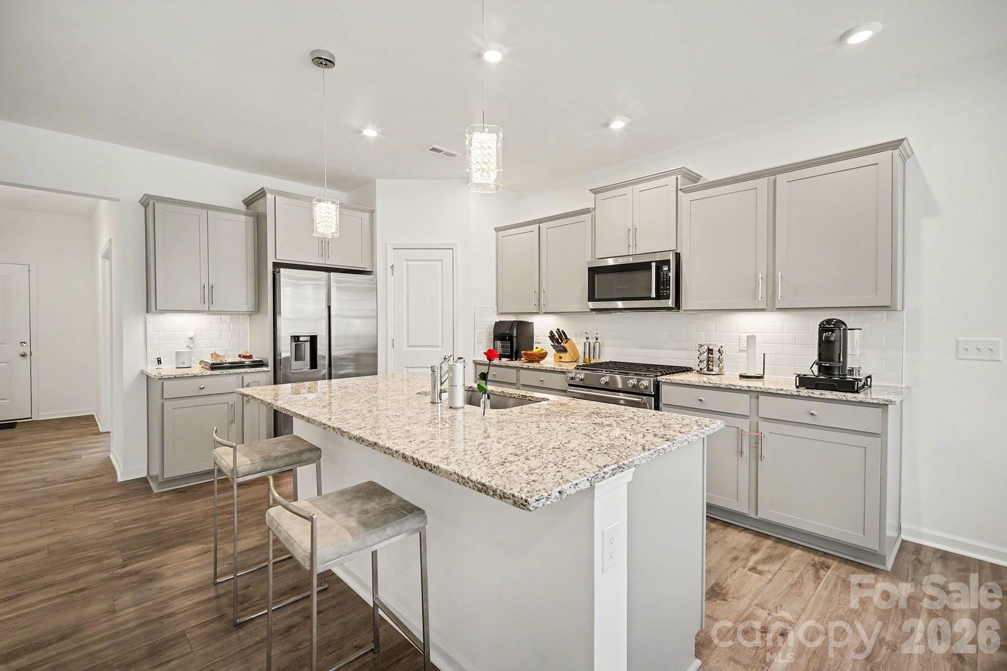 11122 Glasden Road Charlotte, NC 28278 - Photo 13 of 32 a kitchen with a sink stove microwave and refrigerator