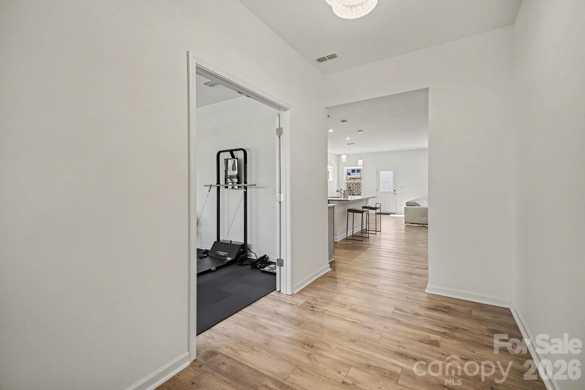 11122 Glasden Road Charlotte, NC 28278 - Photo 16 of 32 a view of a hallway with wooden floor and a living room