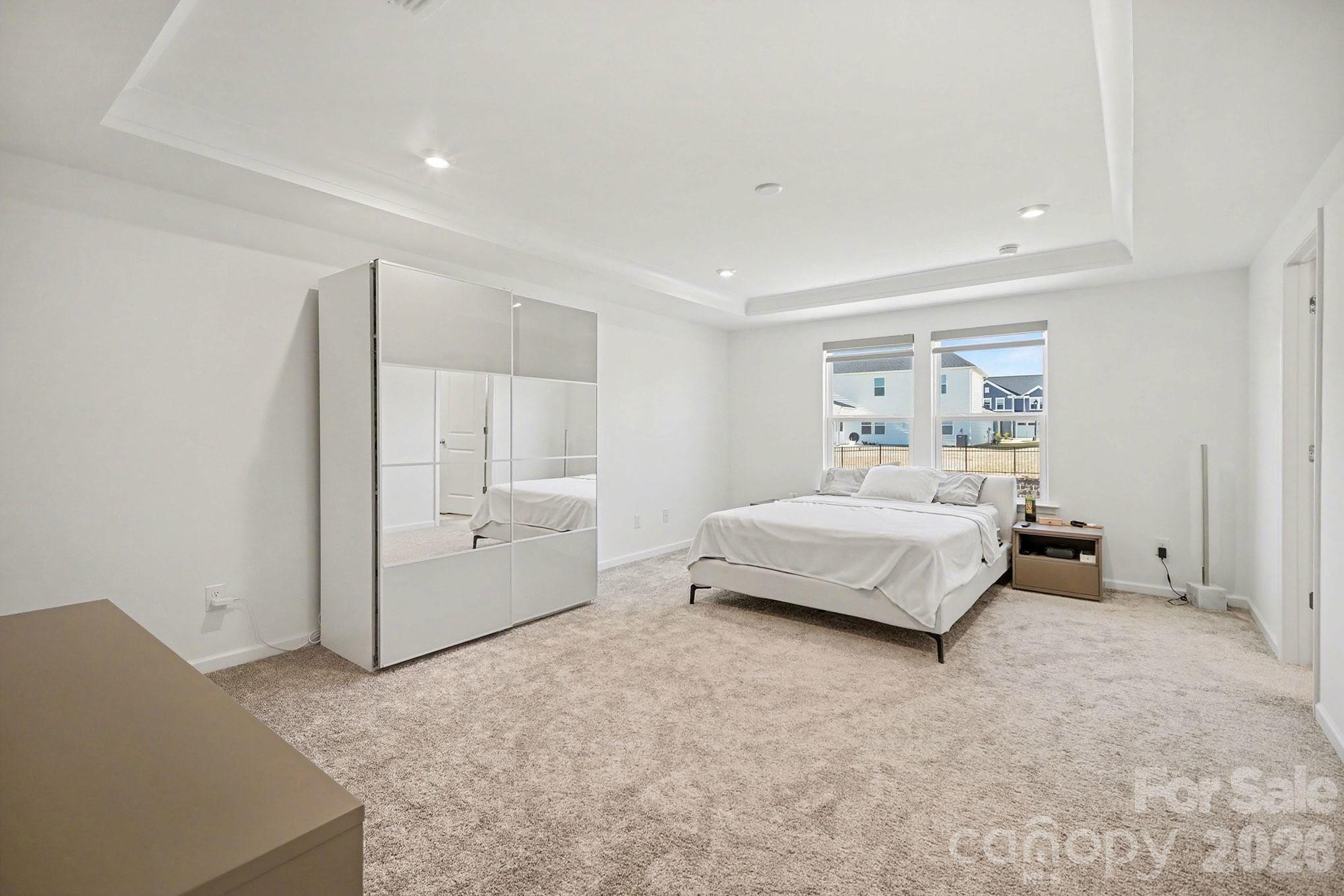 11122 Glasden Road Charlotte, NC 28278 - Photo 19 of 32 a bedroom with a white bed and white cabinets