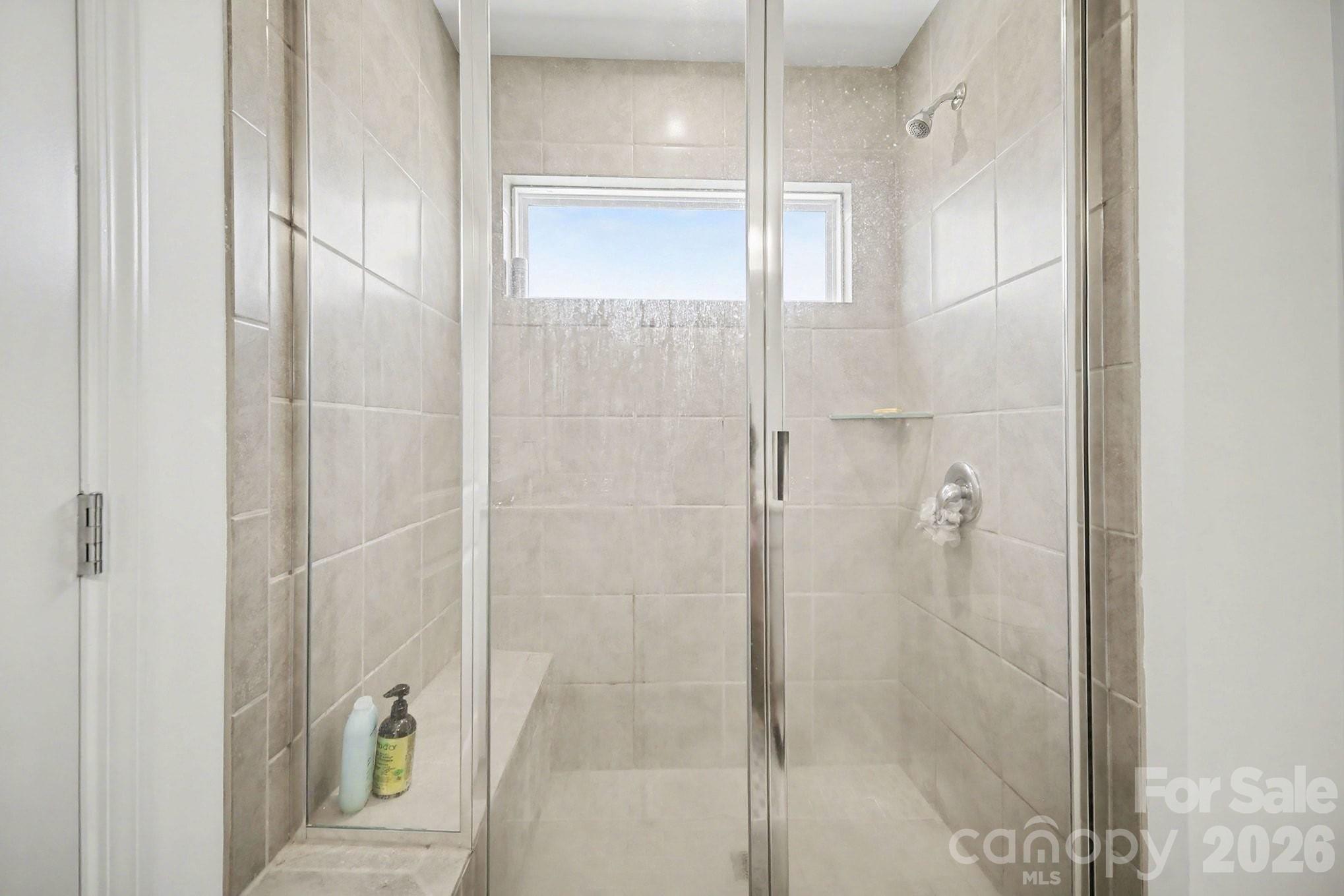 11122 Glasden Road Charlotte, NC 28278 - Photo 23 of 32 a bathroom with a glass shower door
