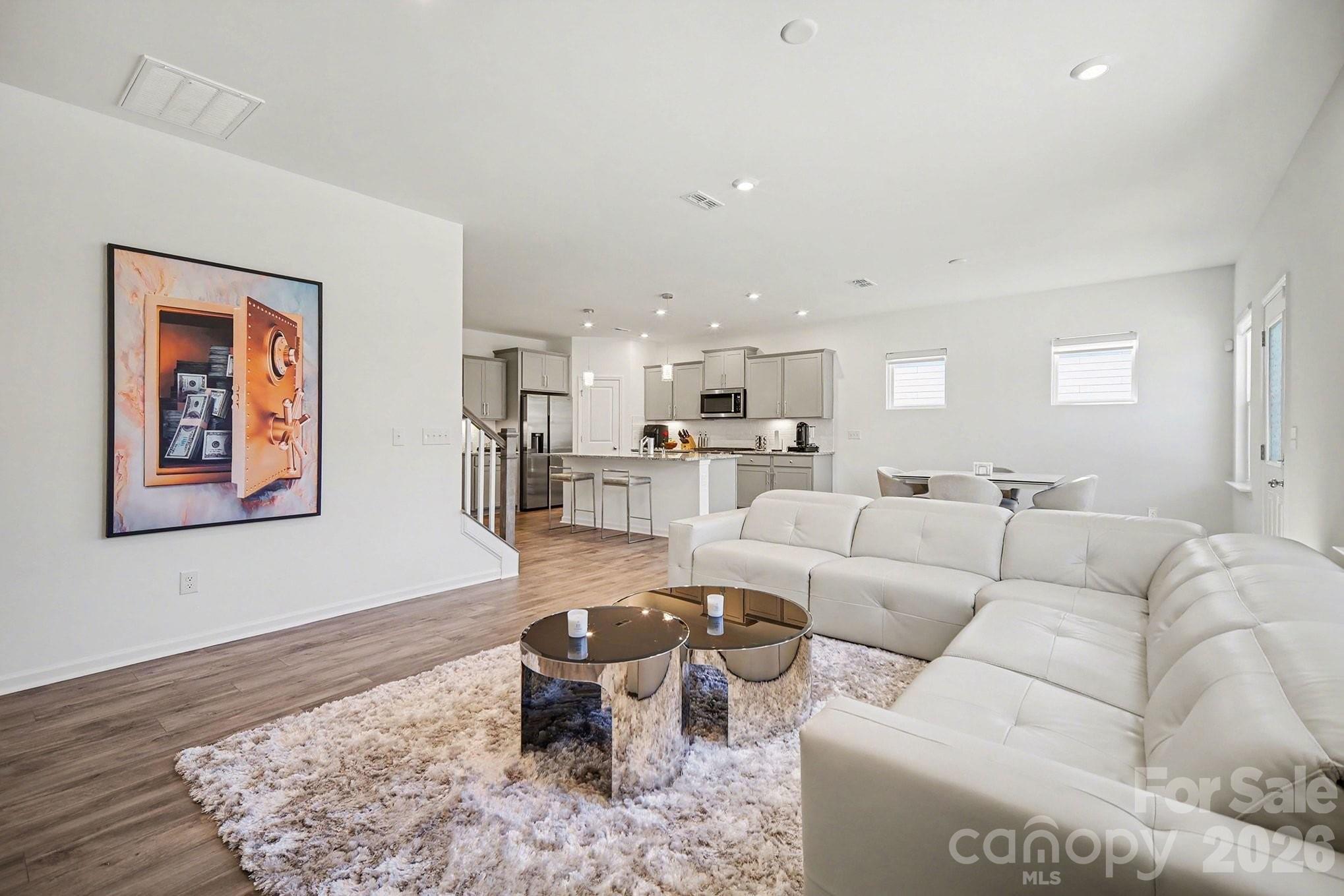 11122 Glasden Road Charlotte, NC 28278 - Photo 3 of 32 a living room with furniture wooden floor and kitchen view