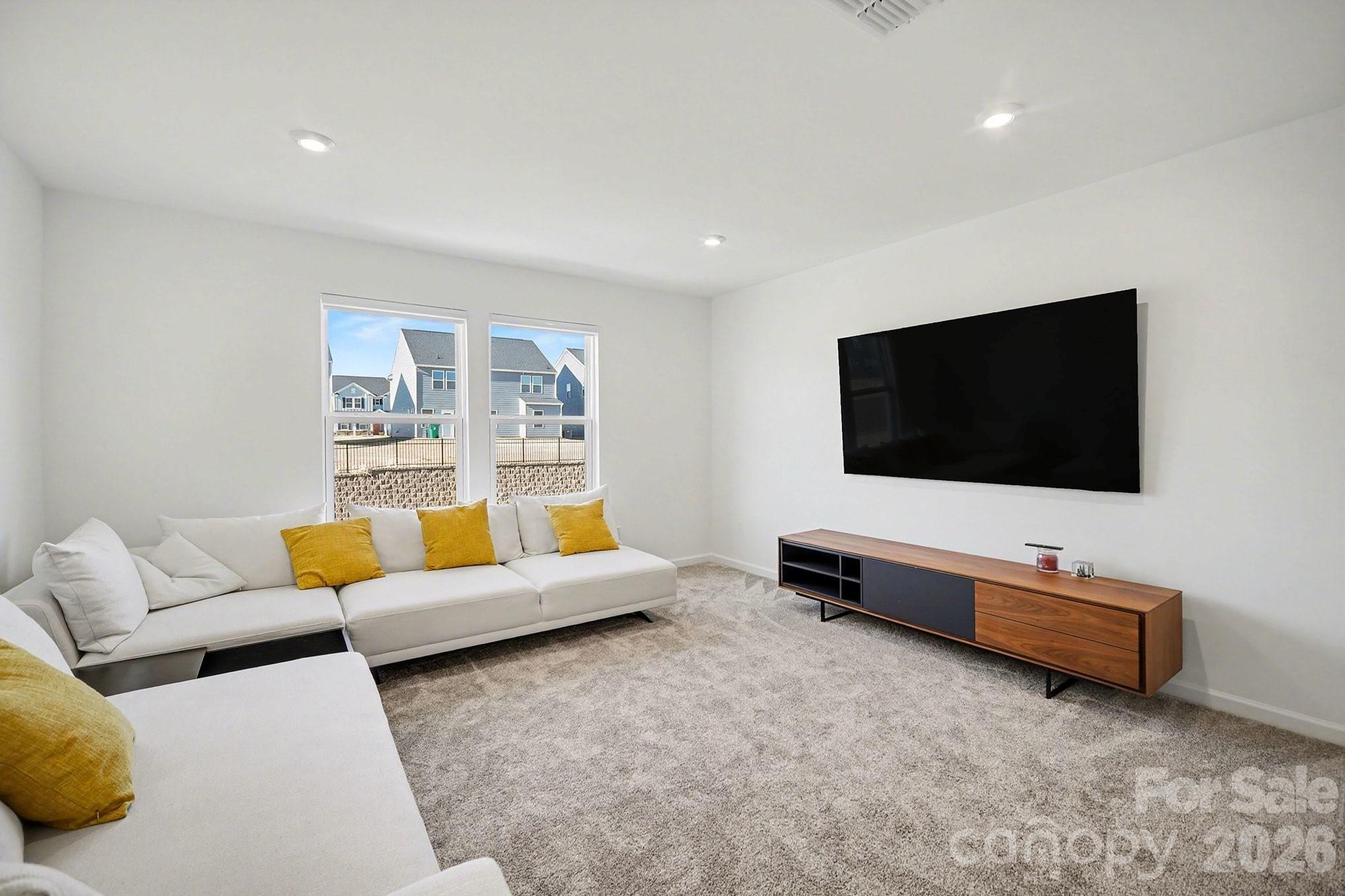 11122 Glasden Road Charlotte, NC 28278 - Photo 6 of 32 a living room with furniture and a flat screen tv