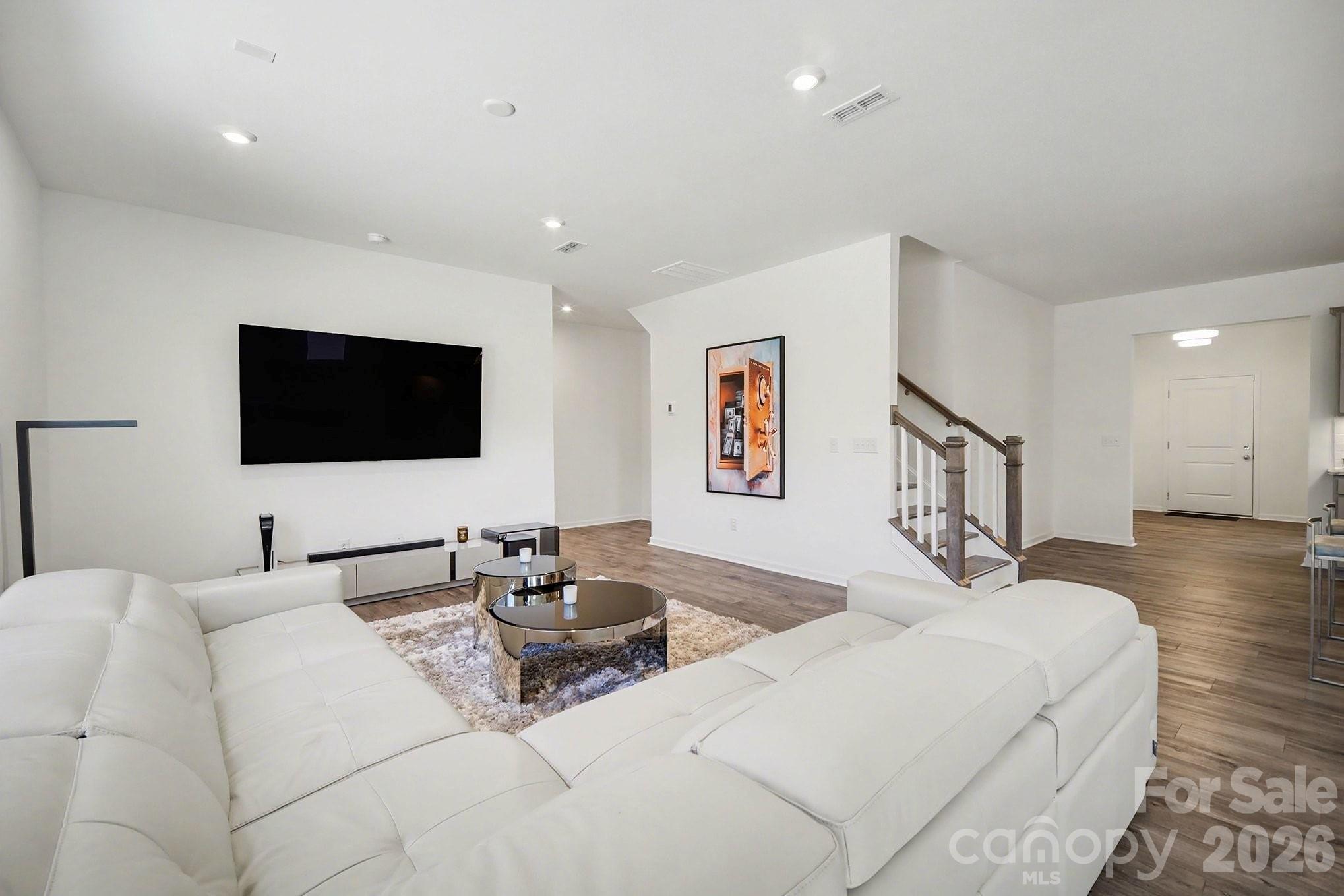 11122 Glasden Road Charlotte, NC 28278 - Photo 7 of 32 a living room with furniture and a flat screen tv