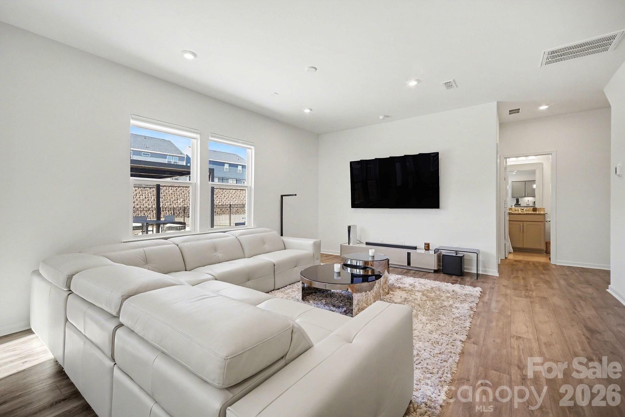 11122 Glasden Road Charlotte, NC 28278 - Photo 8 of 32 a living room with furniture and a flat screen tv