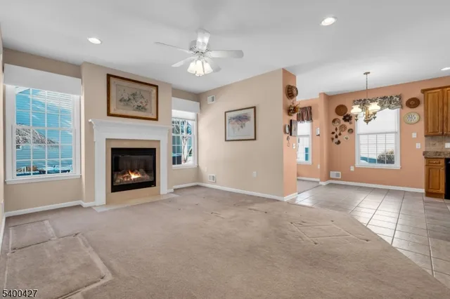 a view of a livingroom with an empty space and a fireplace