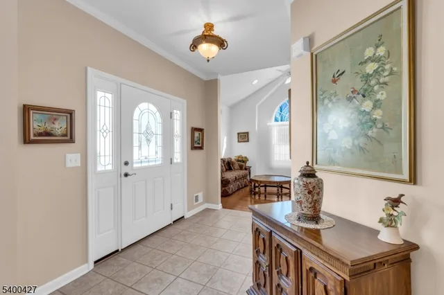 a view of a hallway with workspace and a window