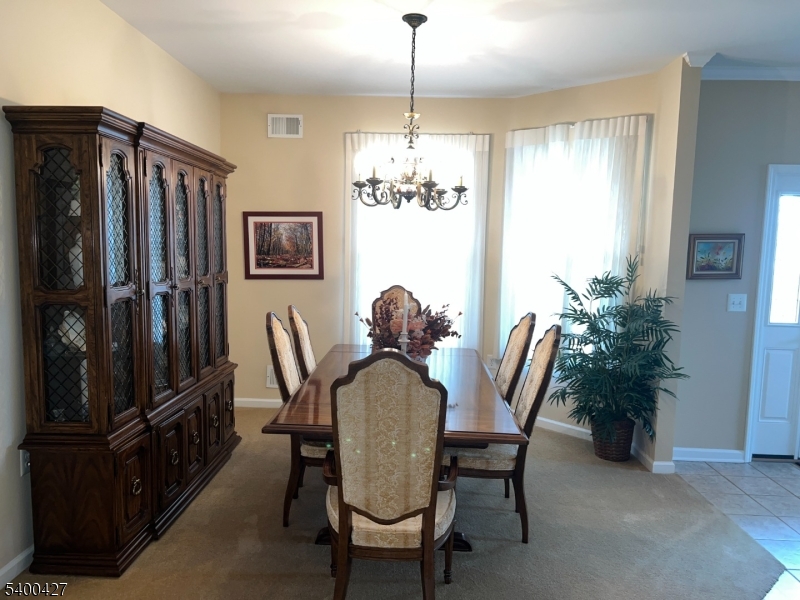 18 Bayard Road Somerset, NJ 08873 - Photo 5 of 15 a view of a dining room with furniture window and wooden floor