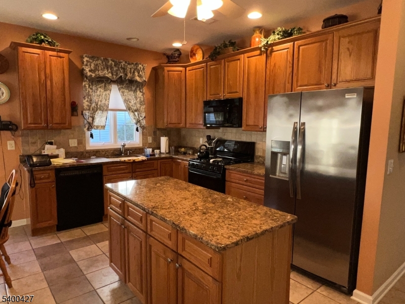 18 Bayard Road Somerset, NJ 08873 - Photo 6 of 15 a kitchen with kitchen island granite countertop a sink a counter top stainless steel appliances and cabinets