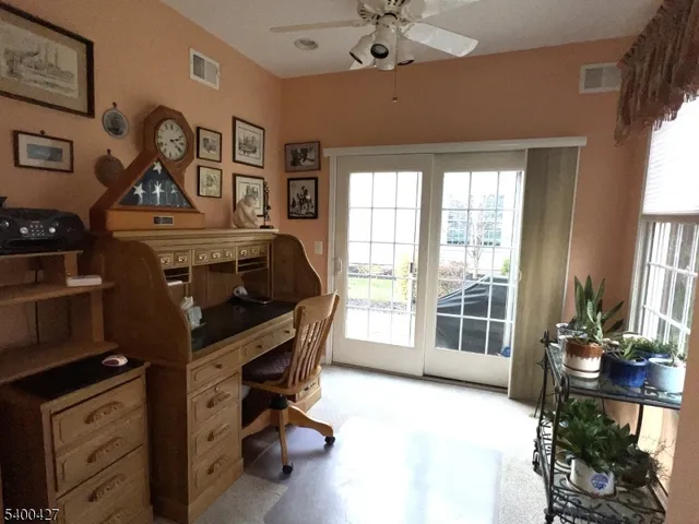 a bedroom with a bed a chandelier and a window