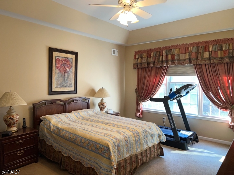 18 Bayard Road Somerset, NJ 08873 - Photo 10 of 15 a bedroom with a bed a chandelier and a window