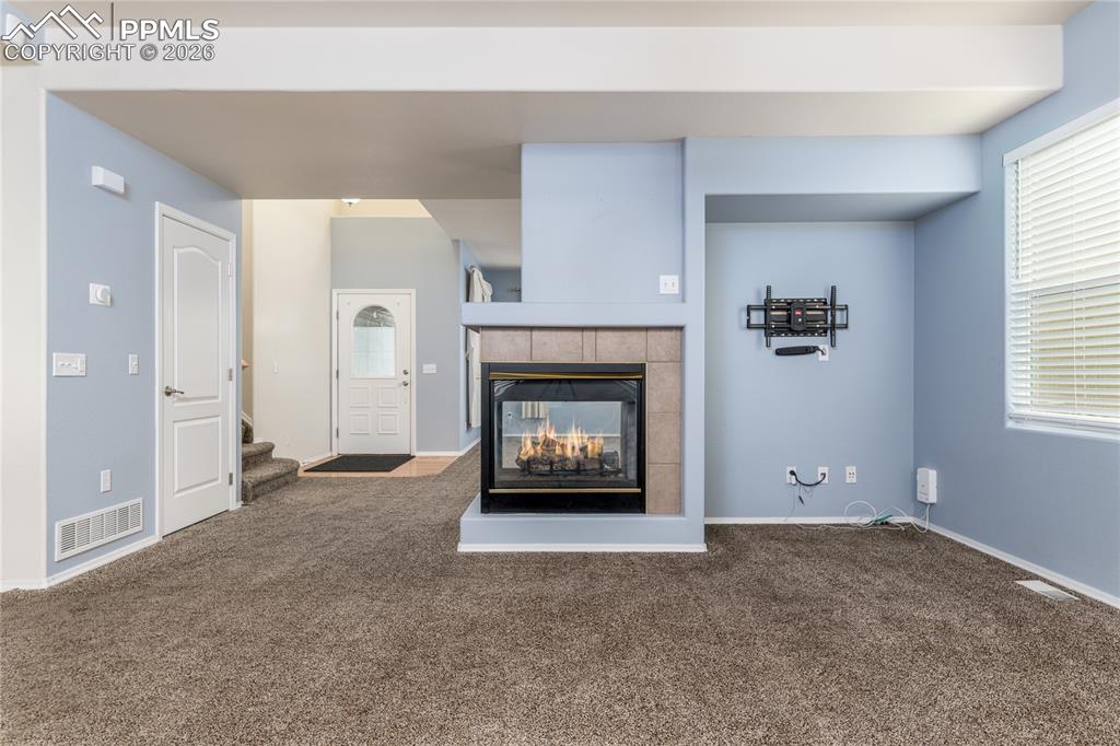 6432 Crystal Mountain Road Colorado Springs, CO 80923 - Photo 11 of 31 a living room with a fireplace