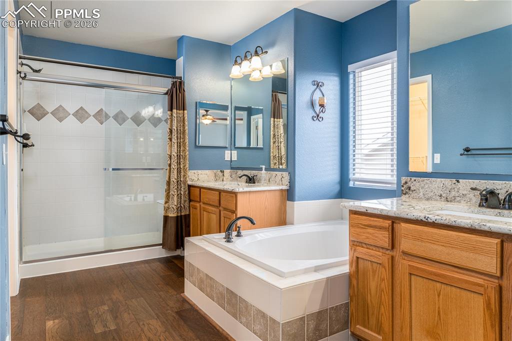 6432 Crystal Mountain Road Colorado Springs, CO 80923 - Photo 17 of 31 a bathroom with a tub sink and mirror
