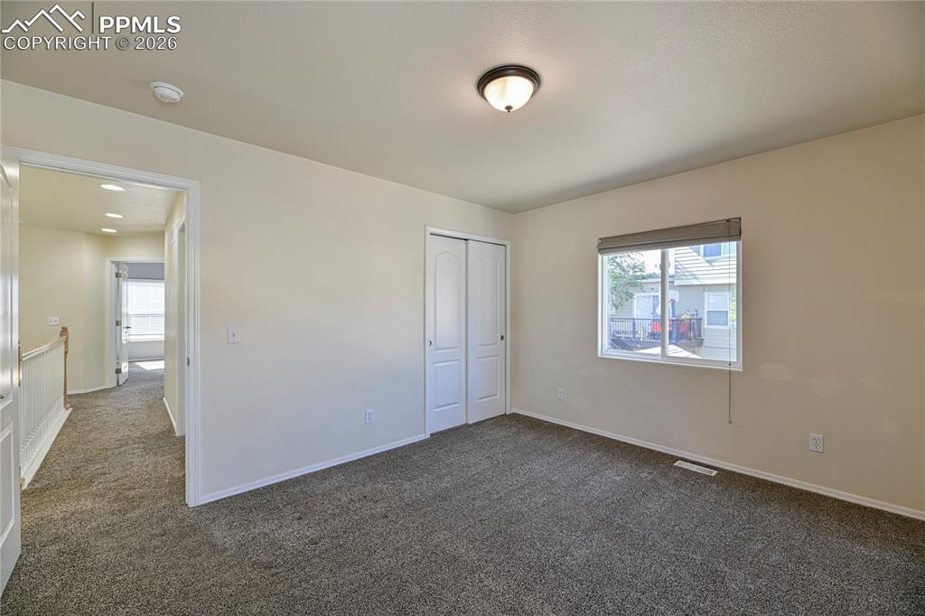 6432 Crystal Mountain Road Colorado Springs, CO 80923 - Photo 21 of 31 an empty room with windows