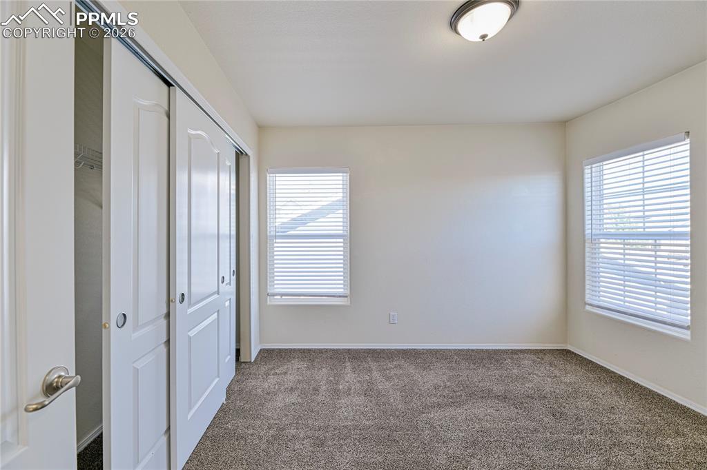 6432 Crystal Mountain Road Colorado Springs, CO 80923 - Photo 22 of 31 an empty room with windows