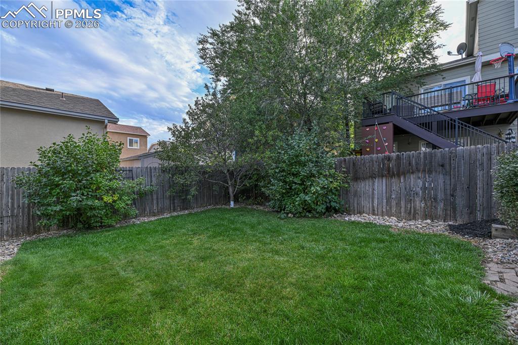 6432 Crystal Mountain Road Colorado Springs, CO 80923 - Photo 31 of 31 a view of backyard of house with green space