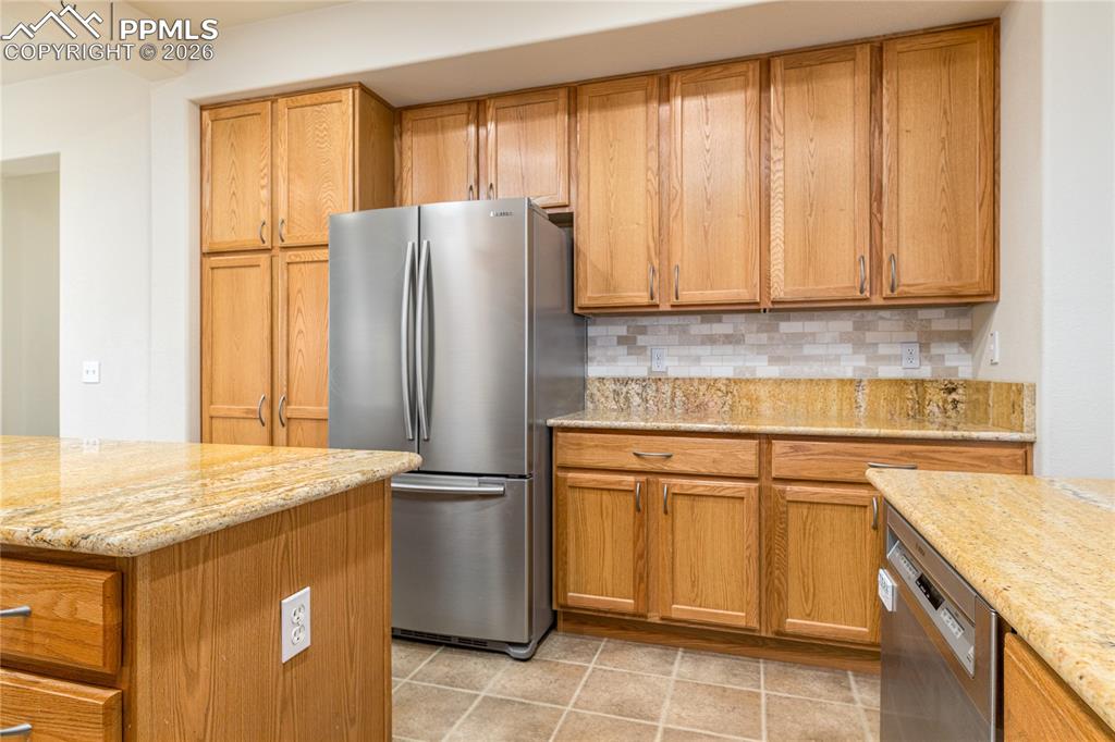 6432 Crystal Mountain Road Colorado Springs, CO 80923 - Photo 5 of 31 a kitchen with appliances cabinets and a counter top space