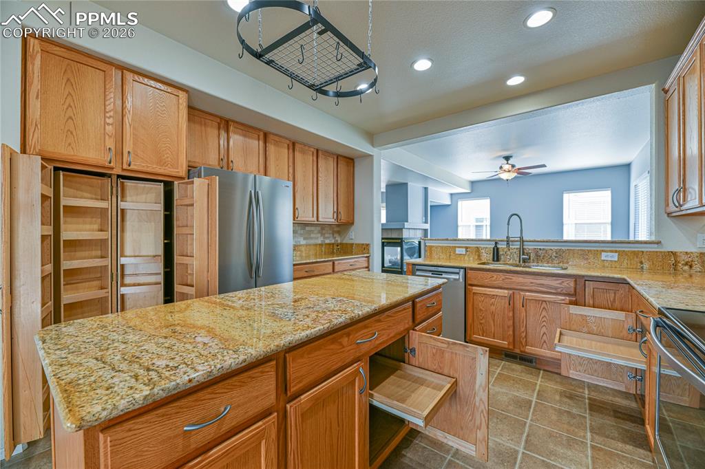 6432 Crystal Mountain Road Colorado Springs, CO 80923 - Photo 8 of 31 a kitchen with stainless steel appliances granite countertop a sink and cabinets
