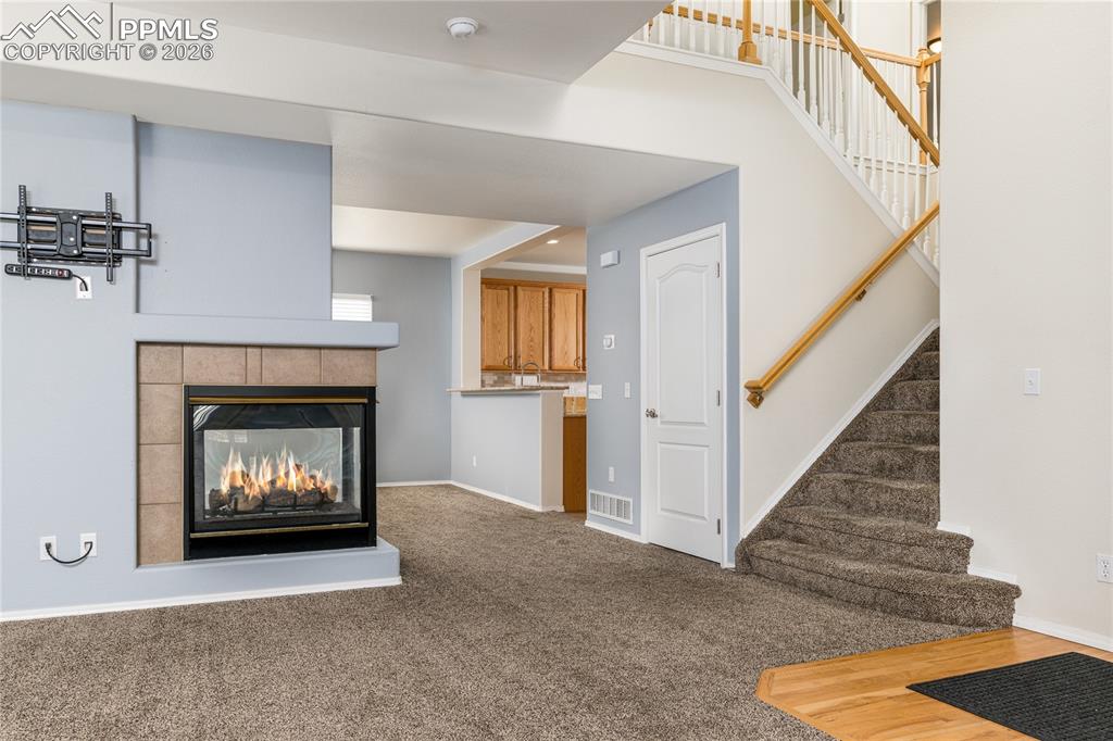6432 Crystal Mountain Road Colorado Springs, CO 80923 - Photo 10 of 31 a living room with a fireplace and a fireplace