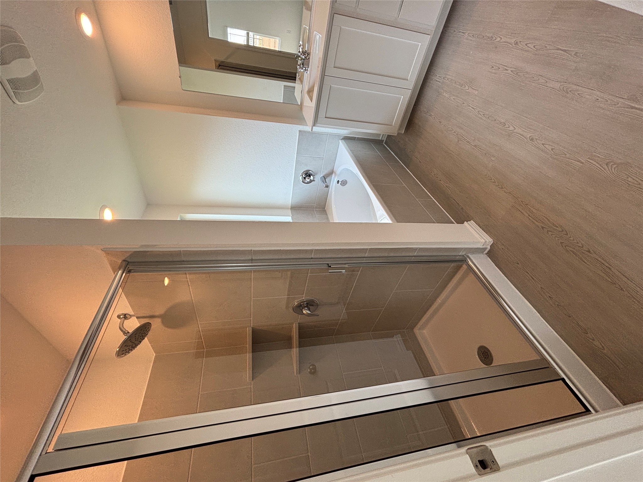 3262 Everett Kyle, TX 78640 - Photo 17 of 24 Bathroom with a garden tub, a stall shower, vanity, and light wood-style floors