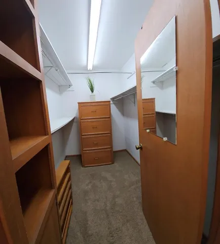 a bathroom with double vanity sinks and a mirror