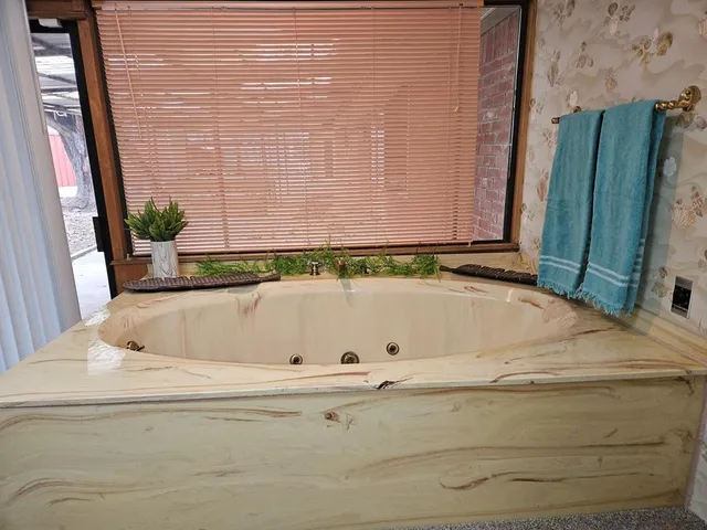 a bathroom with a bathtub and a shower