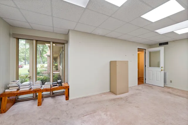a living room with furniture and large windows