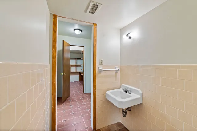 a bathroom with a sink a toilet and mirror