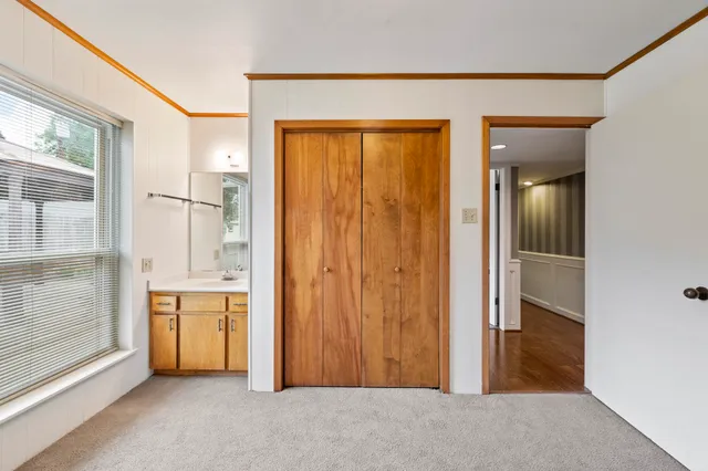 a kitchen with granite countertop white cabinets and a sink