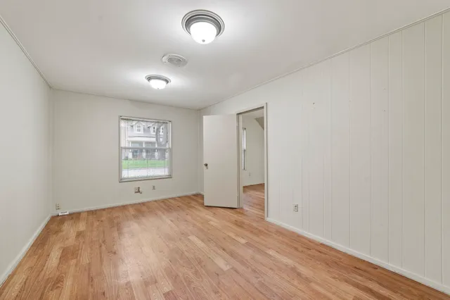 a white toilet sitting next to a bathroom sink and a mirror