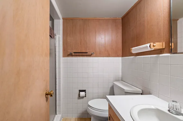 a view of an empty room with furniture and a window